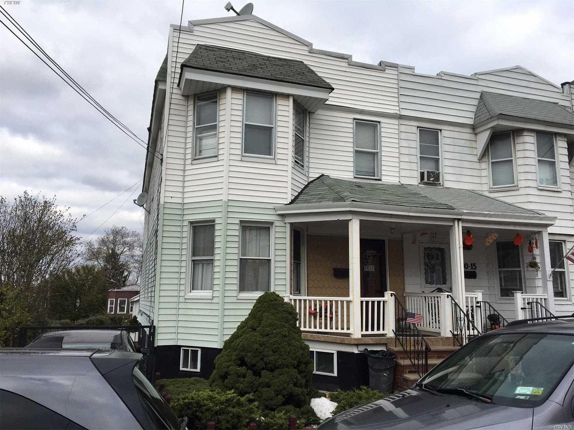 60-13 59th Road Queens, NY 11378 - Photo 2 of 20 a front view of a house with a yard