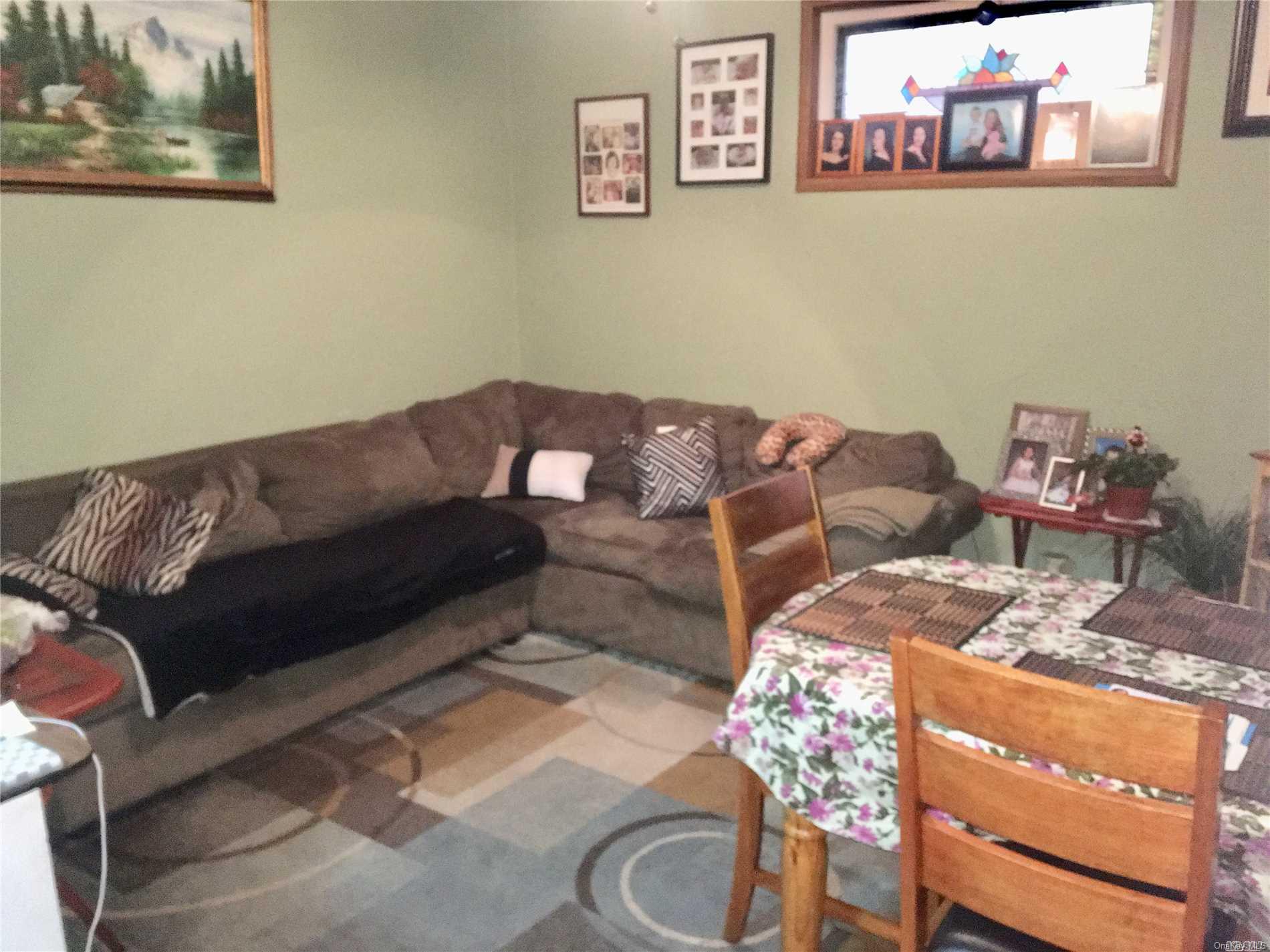 60-13 59th Road Queens, NY 11378 - Photo 10 of 20 a living room with furniture and a couch