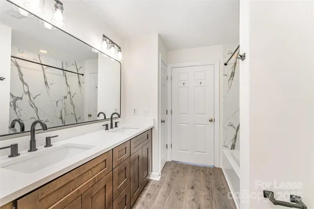 a bathroom with a double vanity sink and mirror