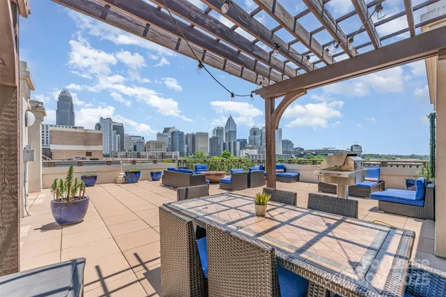 a view of a terrace with furniture and a backyard