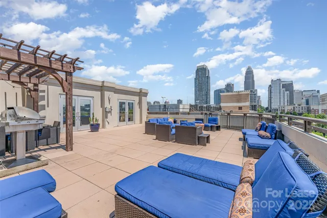 a view of a patio with dining table and chairs with wooden floor