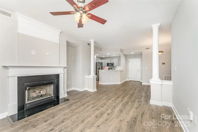 a view of a kitchen an empty room and fire place