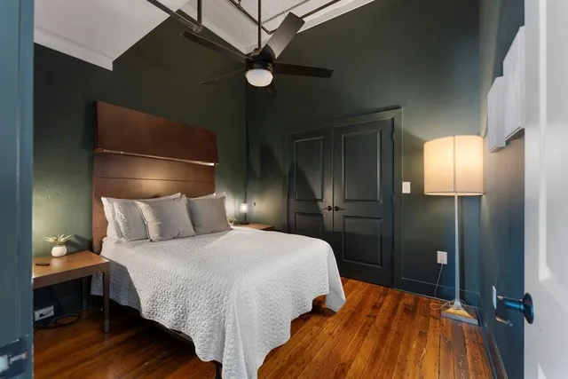 a bedroom with a bed and a lamp on table
