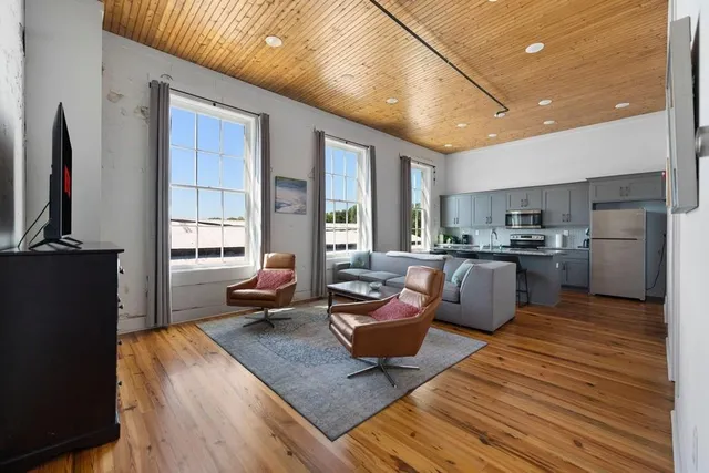 a living room with fireplace furniture and a flat screen tv