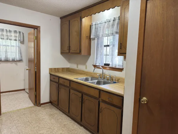 a kitchen with stainless steel appliances granite countertop a sink stove and cabinets