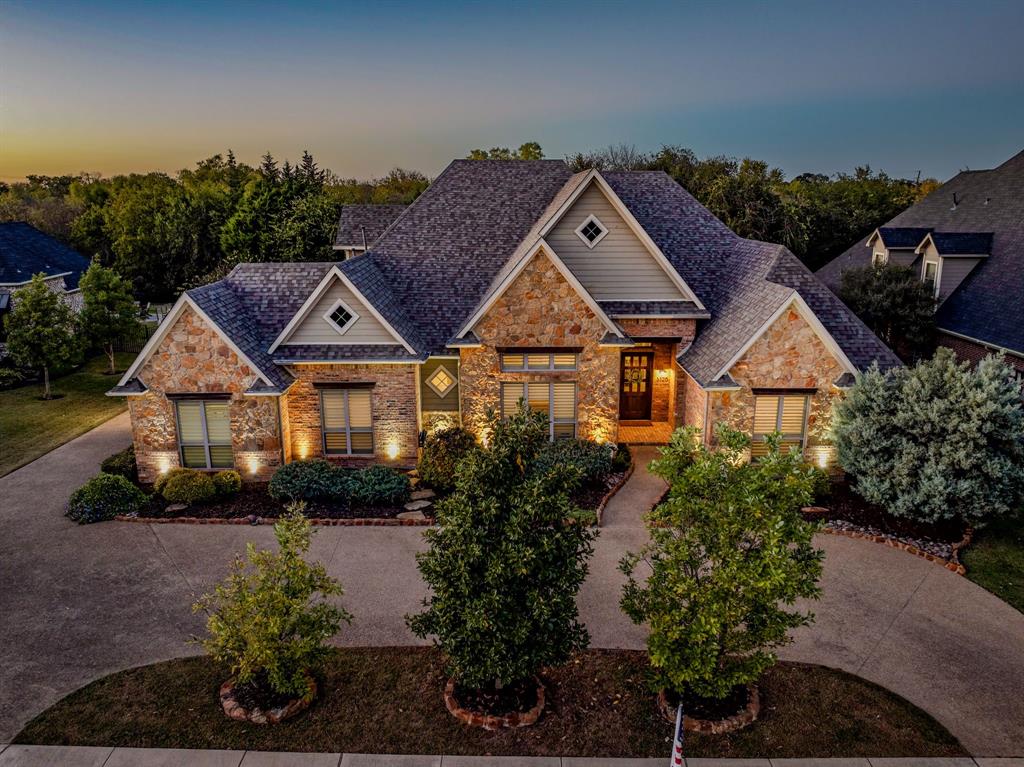 This home shines at dusk with peaceful views of surrounding trees, open greenspace, and the evening sky.