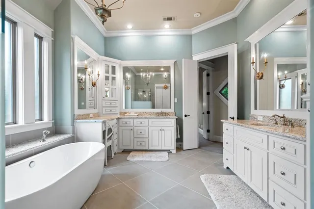 a bathroom with a granite countertop double vanity sink a large mirror a bathtub and shower