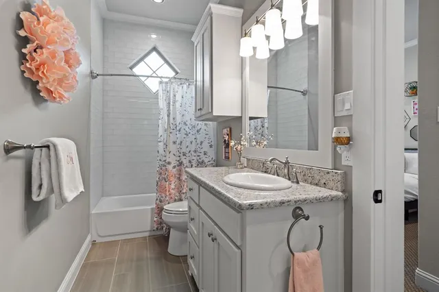 a bathroom with a sink vanity mirror and toilet