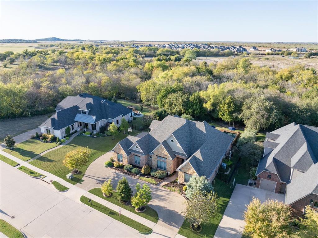 3328 Clubview Drive Denton, TX 76226 - Photo 37 of 40 Backed by trees and greenspace, this home offers a peaceful setting while still being conveniently close to shops, dining, and major highways.