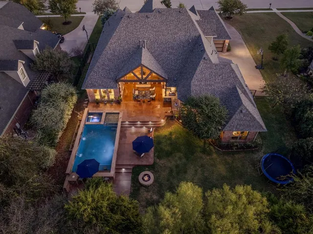 an aerial view of house with yard swimming pool and outdoor seating