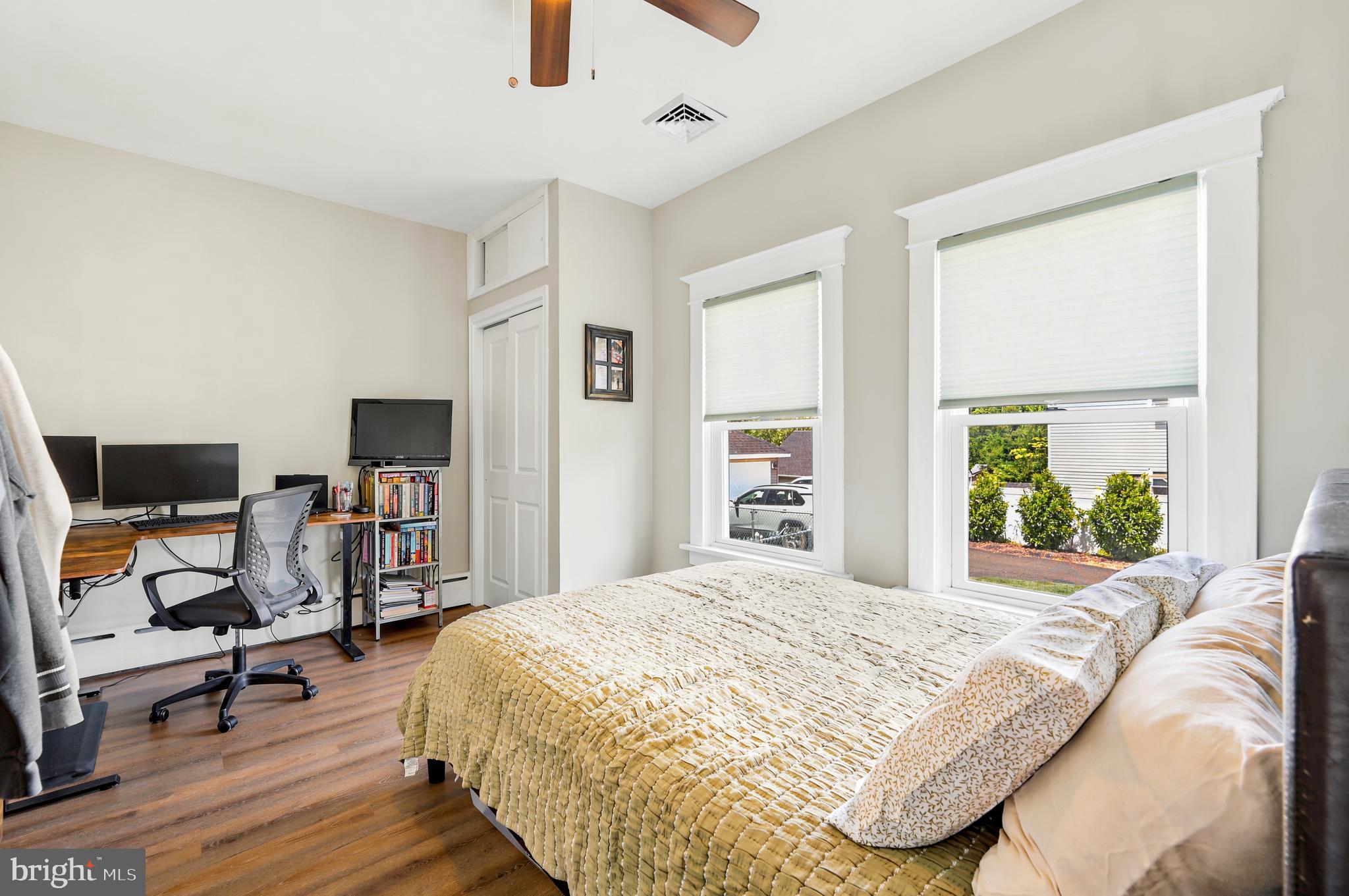 211 North Sylvania Avenue Jenkintown, PA 19046 - Photo 9 of 17 a bedroom with a bed a chair and a large window