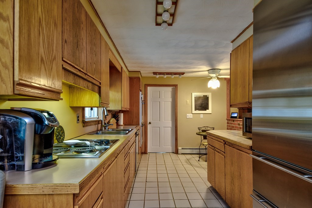 4 Catherine Road Framingham, MA 01701 - Photo 11 of 32 a kitchen with sink cabinets and stove