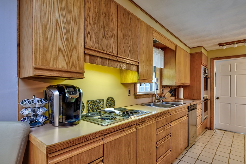 4 Catherine Road Framingham, MA 01701 - Photo 12 of 32 a kitchen with sink cabinets and stove