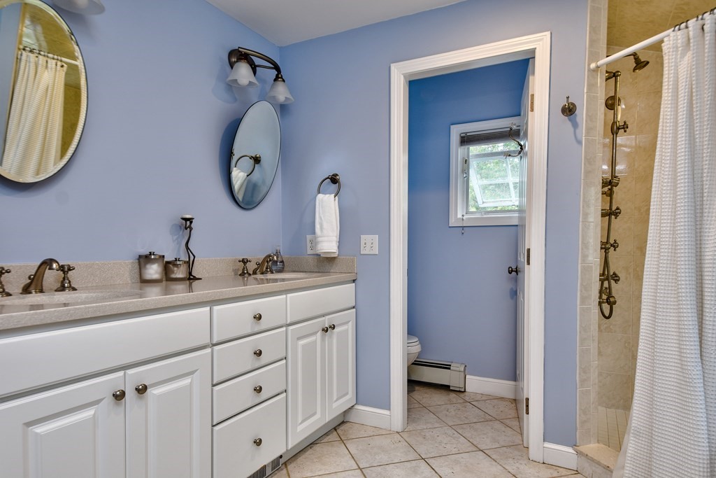 4 Catherine Road Framingham, MA 01701 - Photo 26 of 32 a bathroom with a double vanity sink and a mirror
