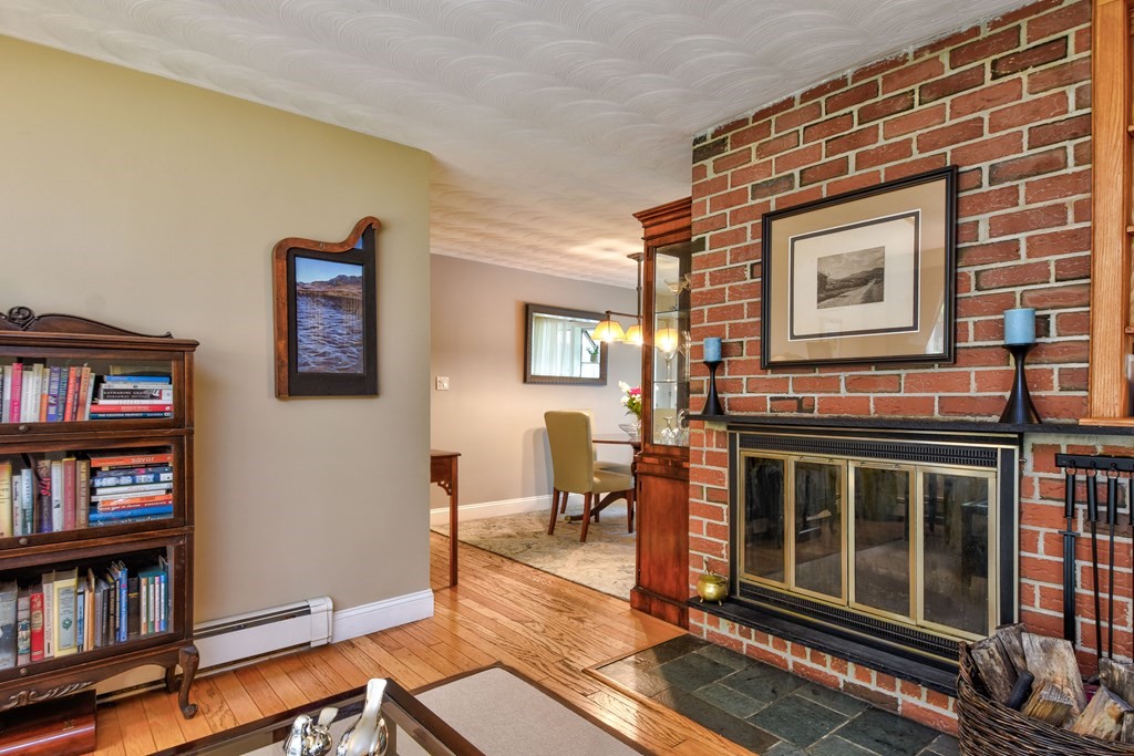 4 Catherine Road Framingham, MA 01701 - Photo 6 of 32 a living room with fireplace furniture and a book shelf