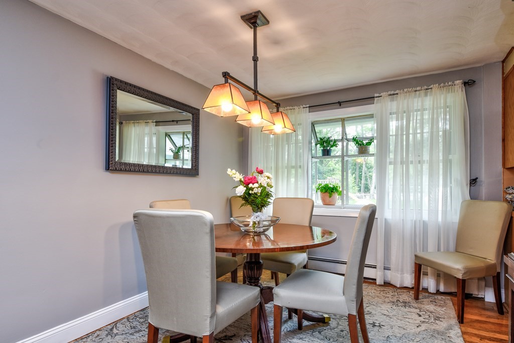 4 Catherine Road Framingham, MA 01701 - Photo 7 of 32 a dining room with furniture a window and a chandelier