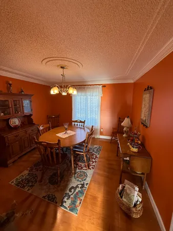 a dining room with furniture and wooden floor