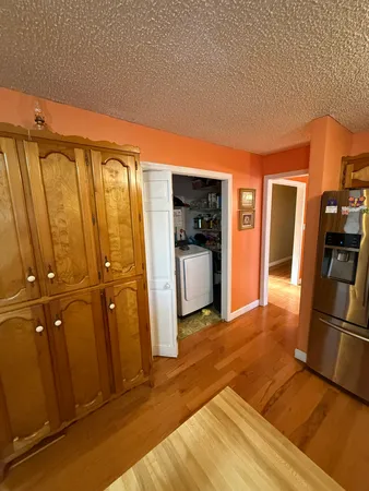 a view of a refrigerator in kitchen and a sink