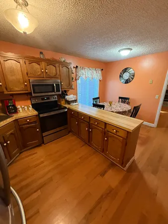a living room with furniture floor to ceiling window and a wooden floor