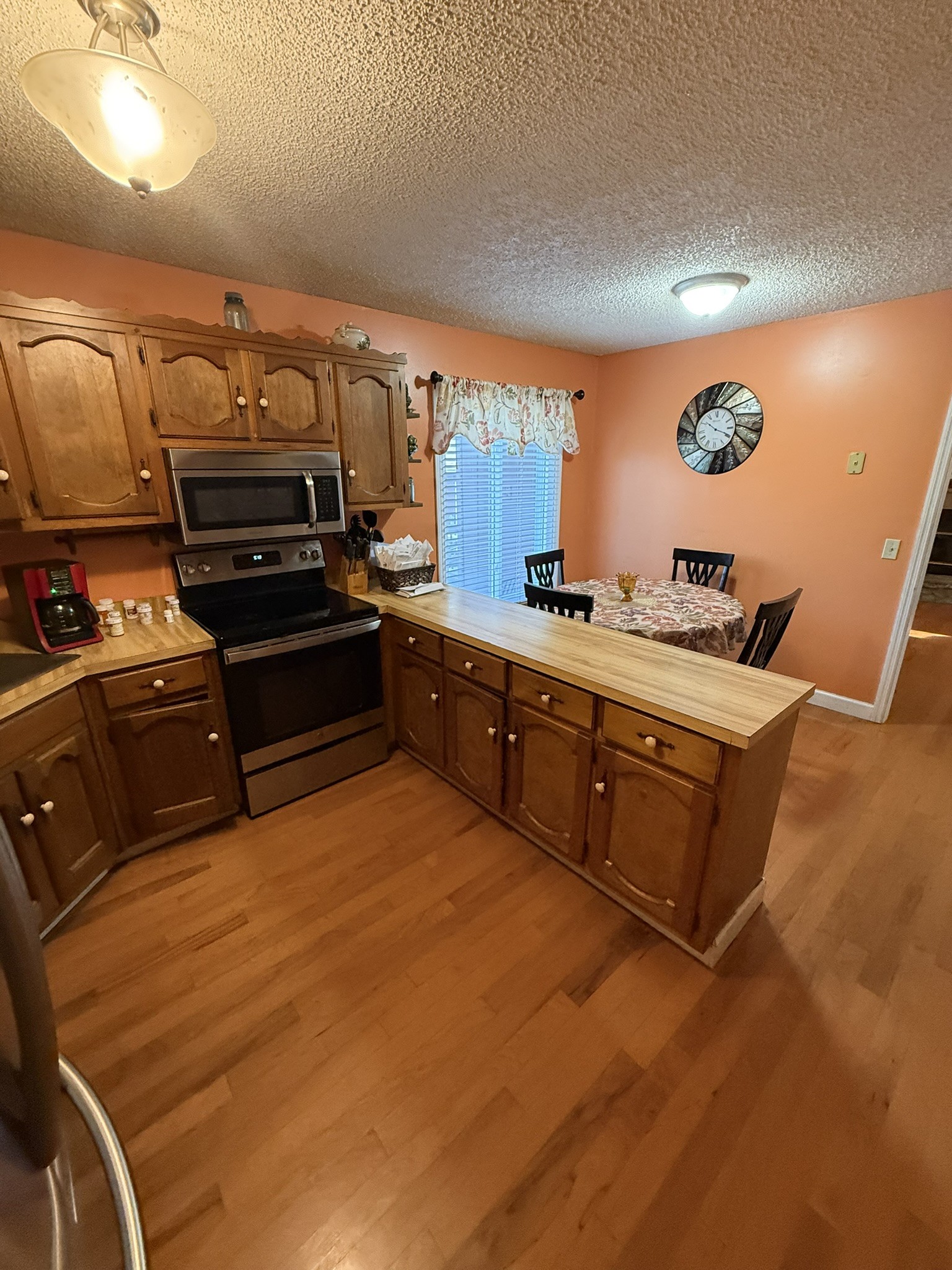 353 Golf Club Road McMinnville, TN 37110 - Photo 27 of 28 a kitchen with wooden cabinets and stainless steel appliances