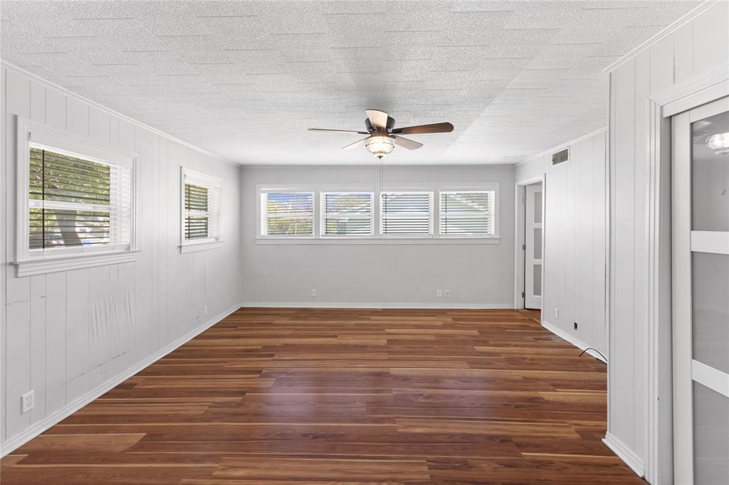 1005 Jernigan Street Commerce, TX 75428 - Photo 20 of 40 a view of an empty room with wooden floor and a window