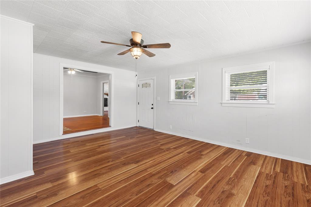 1005 Jernigan Street Commerce, TX 75428 - Photo 22 of 40 a view of empty room with wooden floor and fan