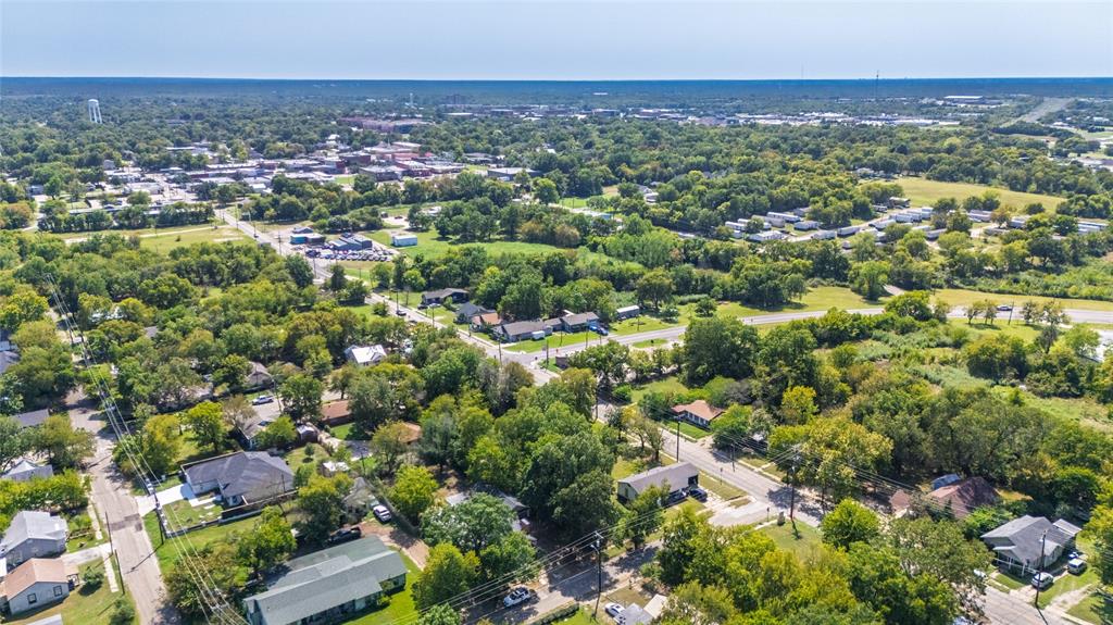 1005 Jernigan Street Commerce, TX 75428 - Photo 29 of 40 an aerial view of a city with lots of residential buildings