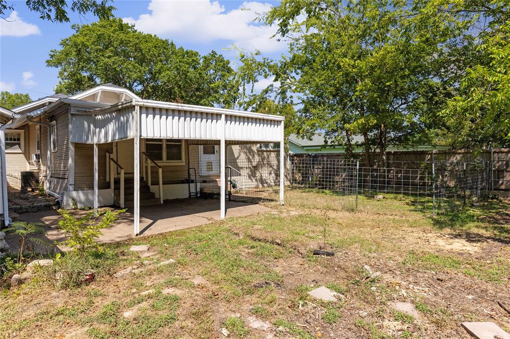 1005 Jernigan Street Commerce, TX 75428 - Photo 30 of 40 a view of a house with a backyard and a patio area with furniture