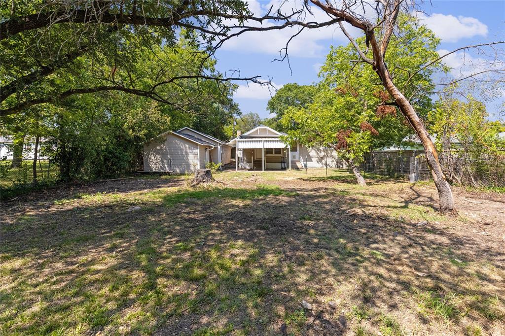 1005 Jernigan Street Commerce, TX 75428 - Photo 31 of 40 a front view of a house with a garden