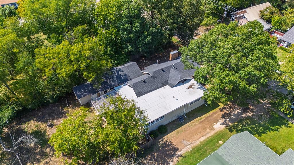 1005 Jernigan Street Commerce, TX 75428 - Photo 33 of 40 an aerial view of a house with a yard