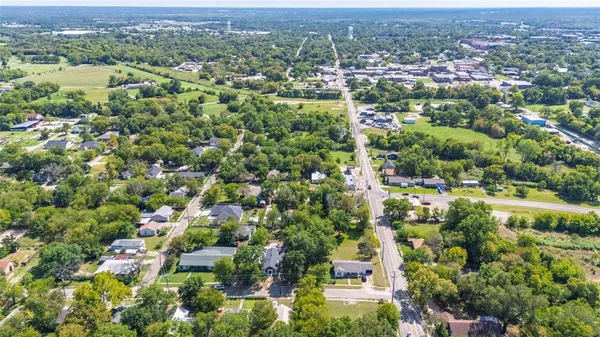 an aerial view of a houses with yard