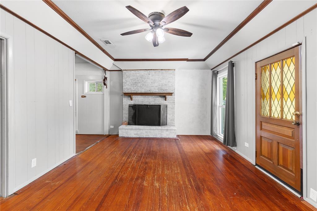 1005 Jernigan Street Commerce, TX 75428 - Photo 6 of 40 a view of empty room with wooden floor and fan