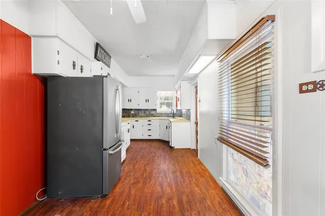 a kitchen with stainless steel appliances a refrigerator and a stove top oven