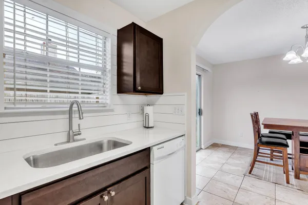 a kitchen with a sink cabinets and a window