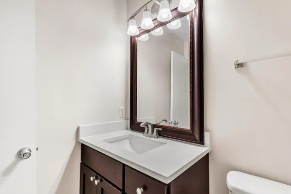 a bathroom with a sink a toilet and a mirror