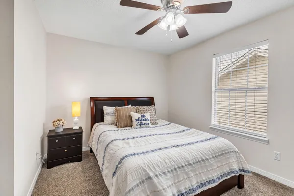 a bedroom with a bed and a chandelier