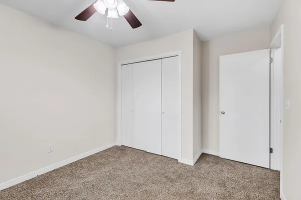 an empty room with a ceiling fan