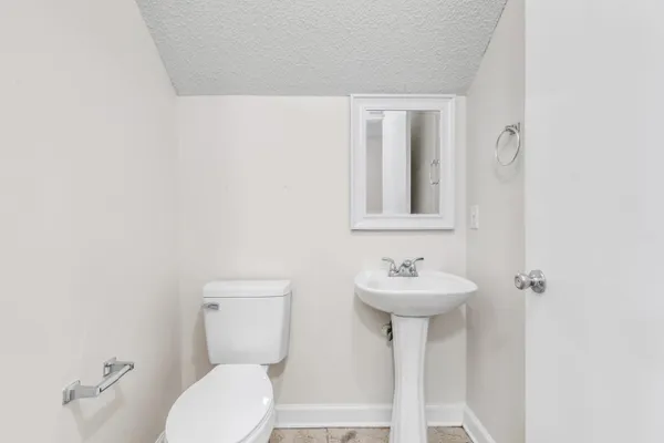 a bathroom with a sink mirror and toilet