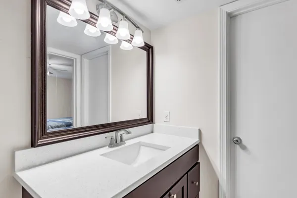a bathroom with a sink vanity and a mirror