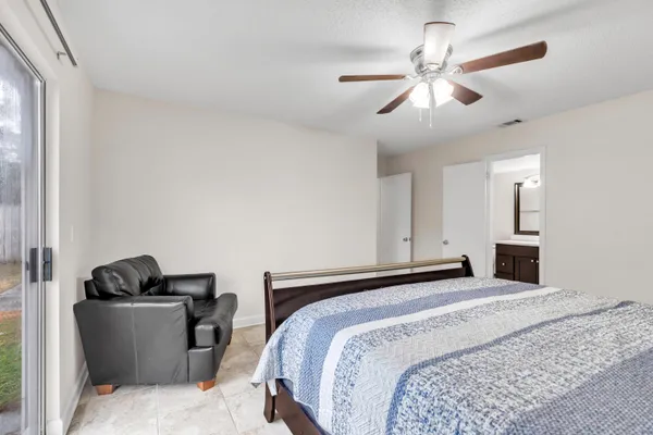 a bedroom with a bed and ceiling fan