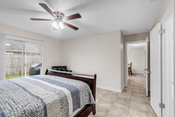 a bedroom with a bed and a large mirror