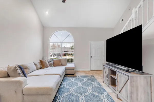 a living room with furniture and a flat screen tv