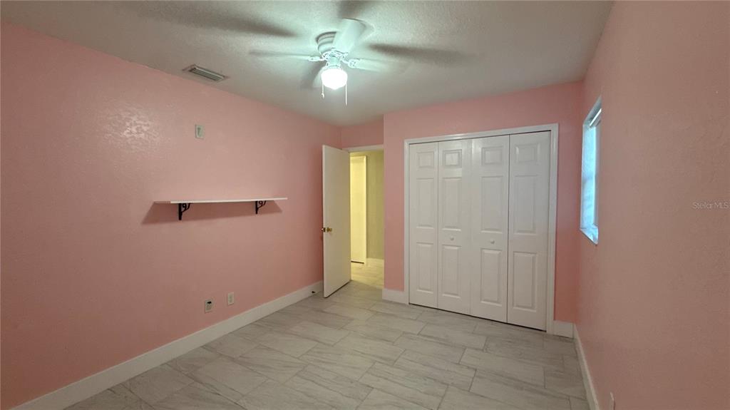 8106 Wichita Way Tampa, FL 33619 - Photo 20 of 21 an empty room with closet and fan