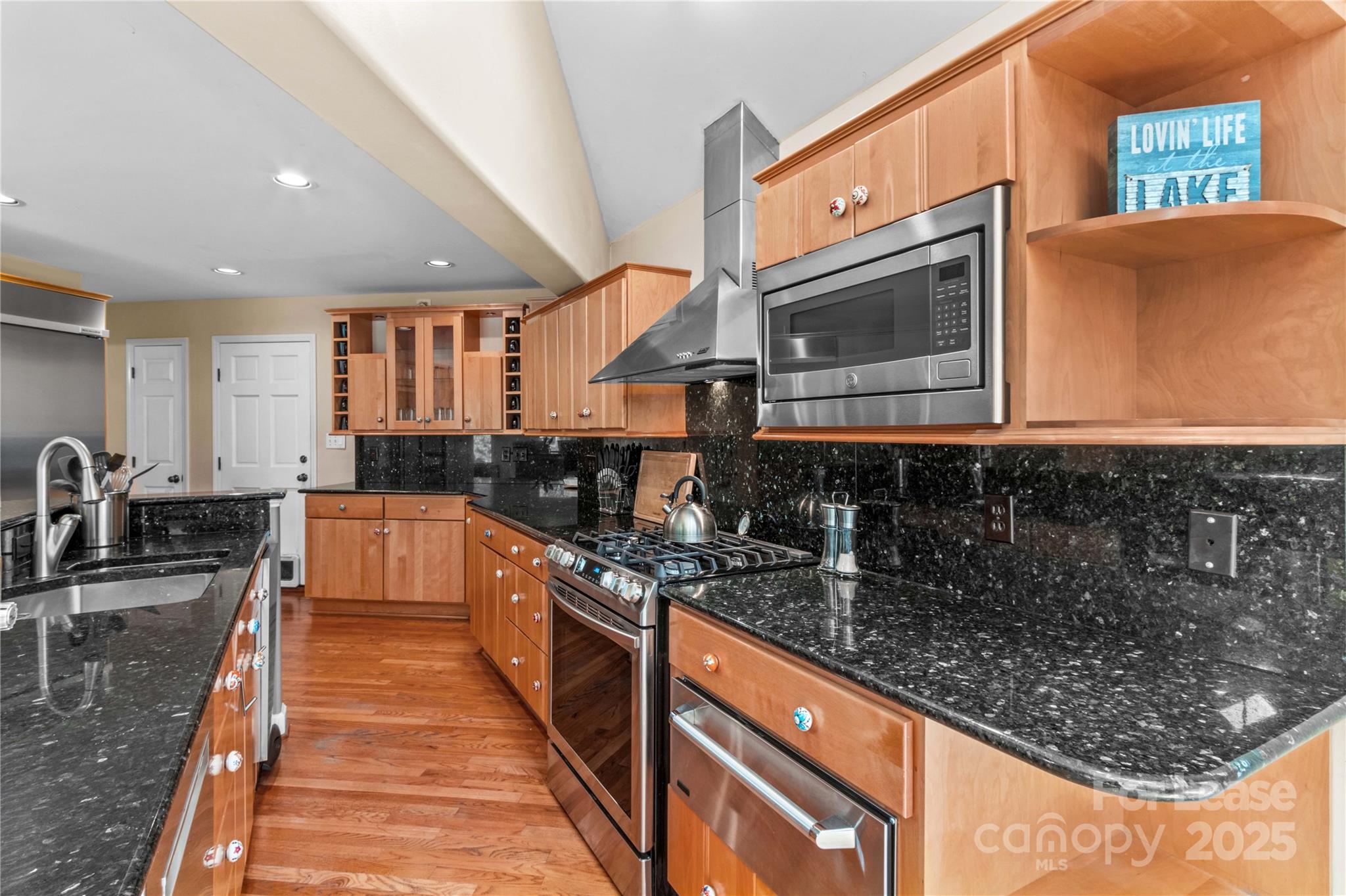 709 Normandy Road Mooresville, NC 28117 - Photo 15 of 46 a kitchen with stainless steel appliances granite countertop a stove a sink and a microwave