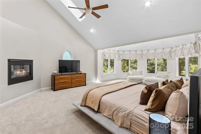 a bedroom with a bed and large windows