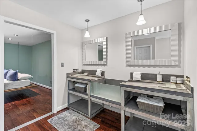 a bathroom with a granite countertop toilet sink and mirror