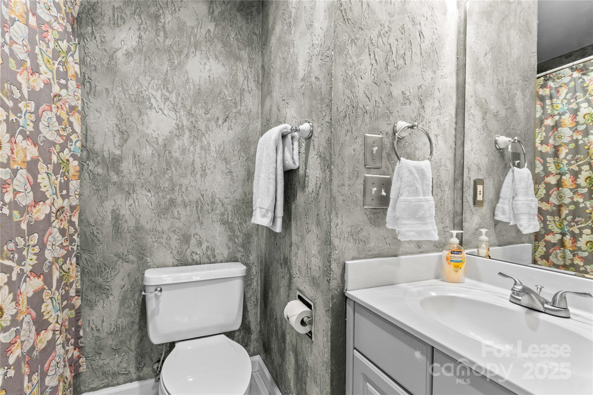 709 Normandy Road Mooresville, NC 28117 - Photo 29 of 46 a bathroom with a granite countertop toilet sink and mirror