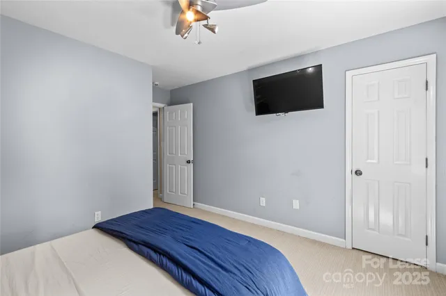 a bedroom with a bed and a night stand