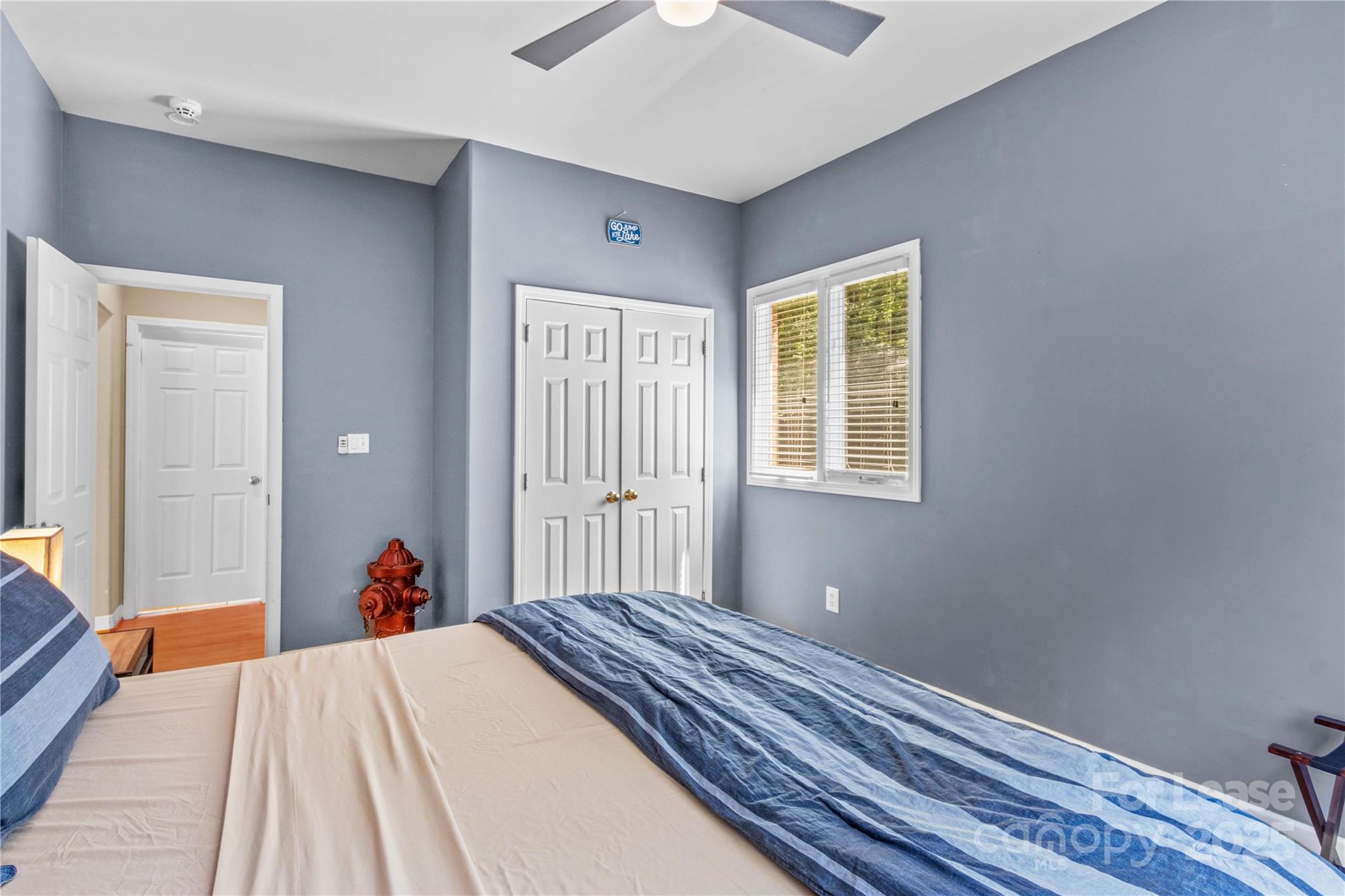 709 Normandy Road Mooresville, NC 28117 - Photo 37 of 46 a bed room with a bed and a chandelier