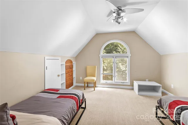 a bedroom with bed and a chandelier